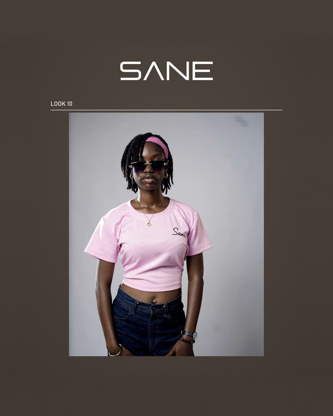 Model wearing the pink Sane Crop Top with black script