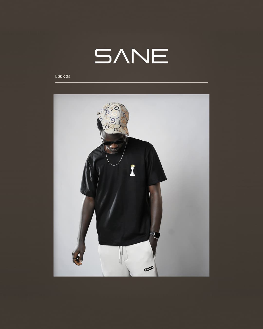 Model wearing the black Crown Tee with crowned pawn chest print