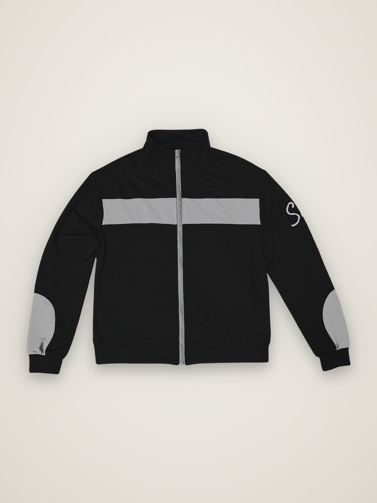 The Tracksuit jacket, front view with zip and grey chest stripe